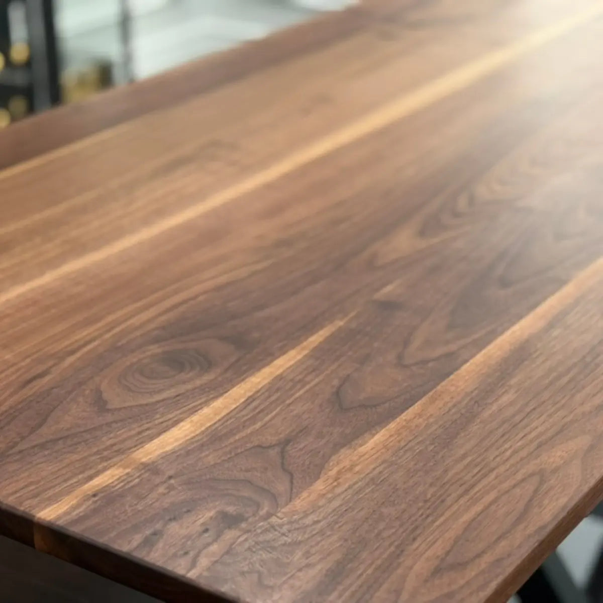 Close-up of walnut tabletop showing natural grain patterns