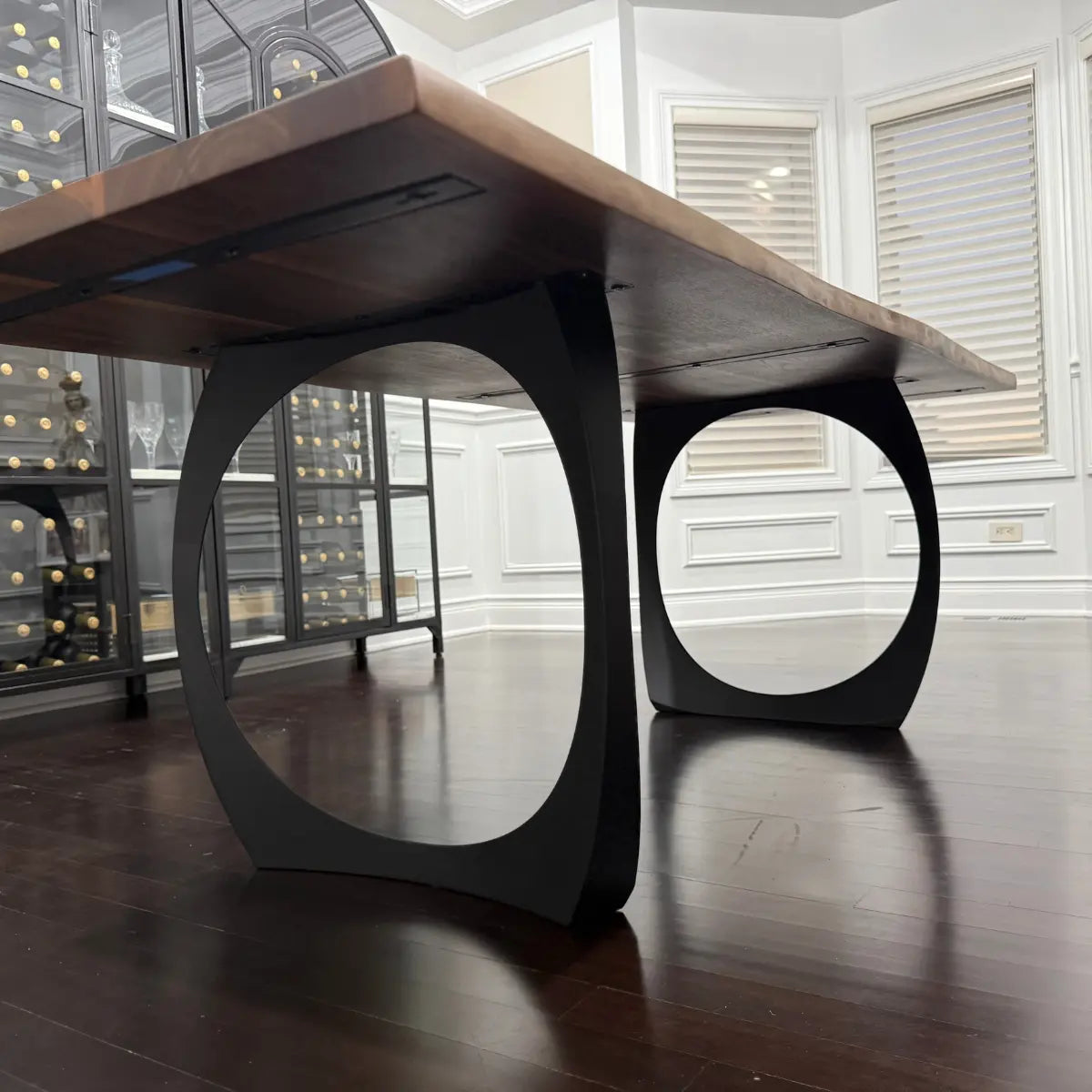 Black walnut dining table showing black metal legs