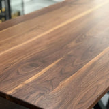 Close-up of walnut tabletop showing natural grain patterns 