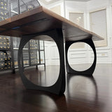 Black walnut dining table showing black metal legs 