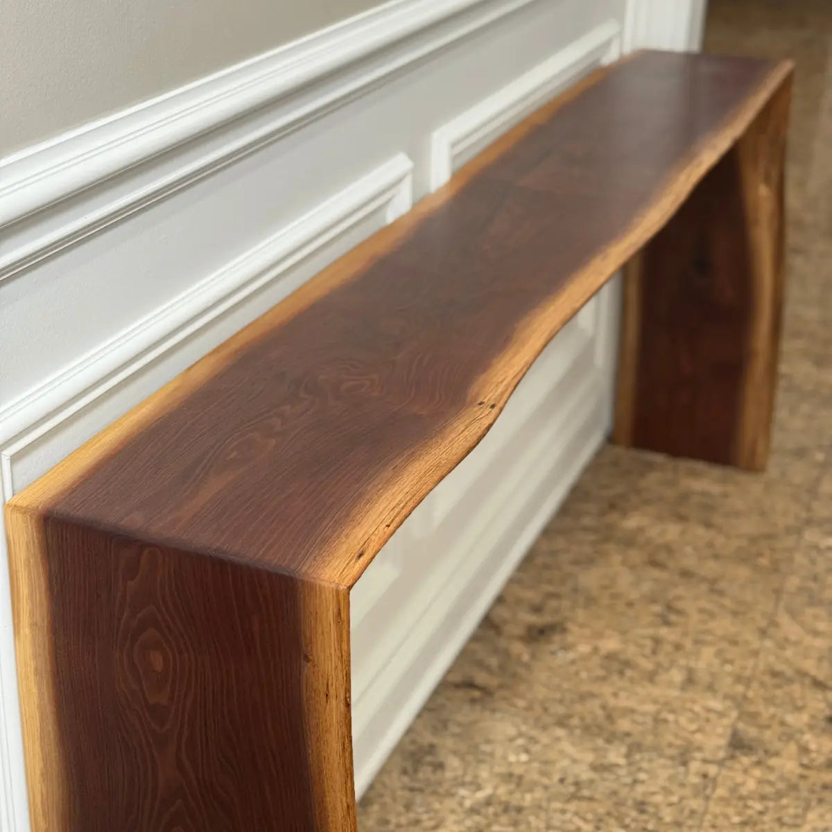 walnut live edge console table close up to white wall